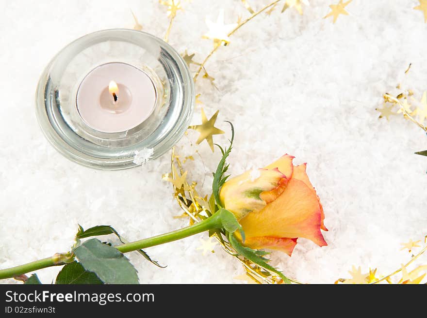 Beautiful rose and the burning candle on the snow. Beautiful rose and the burning candle on the snow