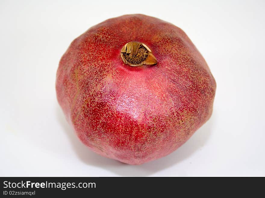 Bright red pomegranate on white background isolated