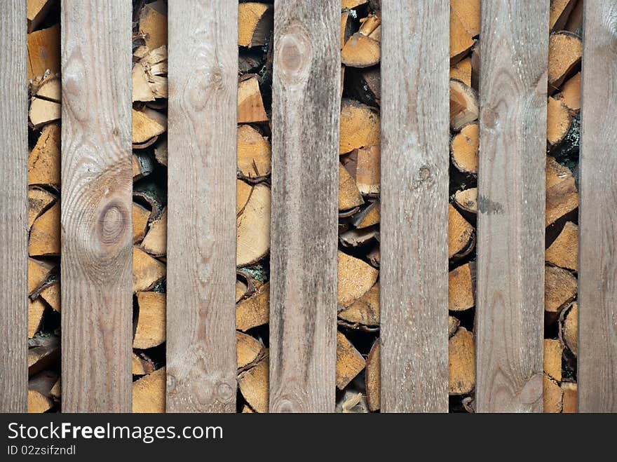 Woodched outside. Stack of wood.