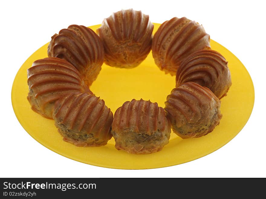 Eclairs on a plate, isolated on a white background