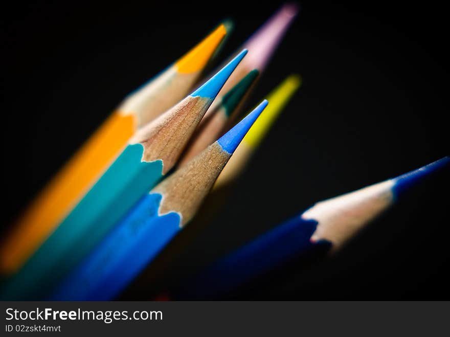 Color pencils arrange over  black background. Color pencils arrange over  black background