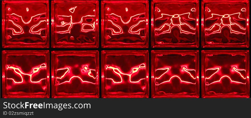 Red neon designs on glass tiles at night. Red neon designs on glass tiles at night