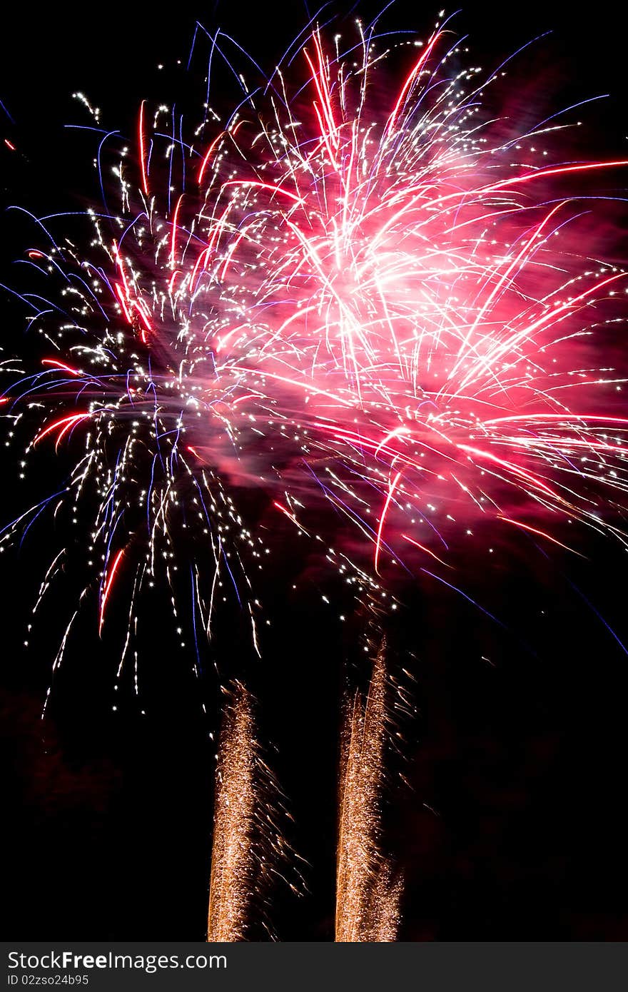 Brightly coloured fireworks against a black night sky