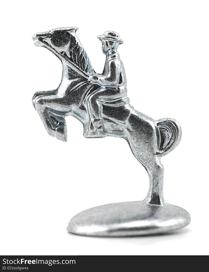 Studio shot of equestrian, jumping horse isolated on white. Table game silver metal figure.