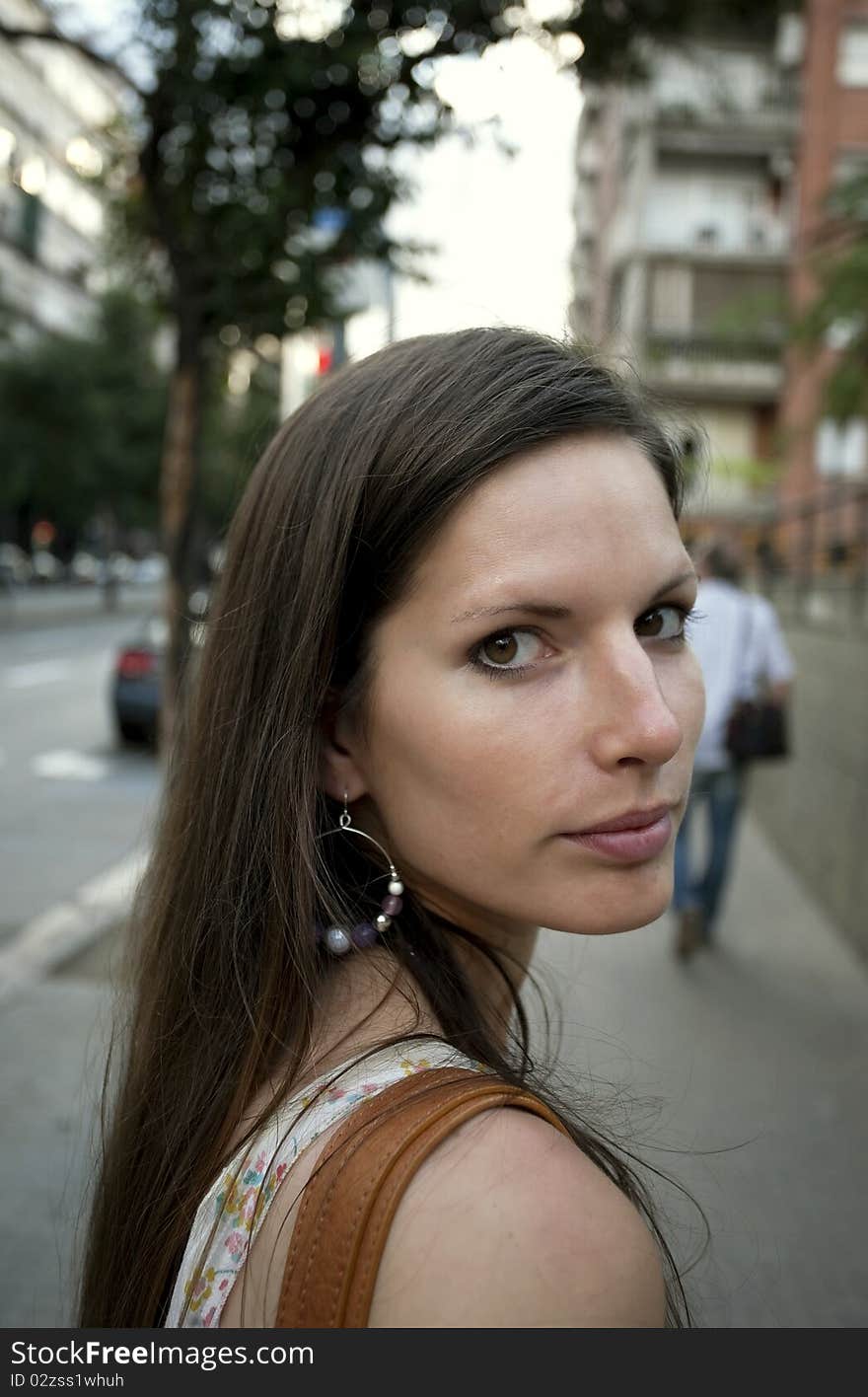 Woman running along the street and looks back. Woman running along the street and looks back