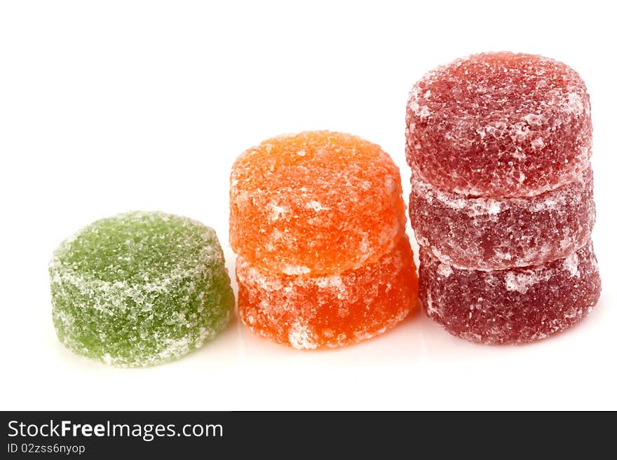 Red green and orange fruit sweets on a white background. Red green and orange fruit sweets on a white background