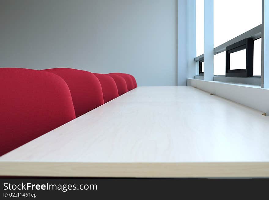 Long desk in front of a large window. Long desk in front of a large window.