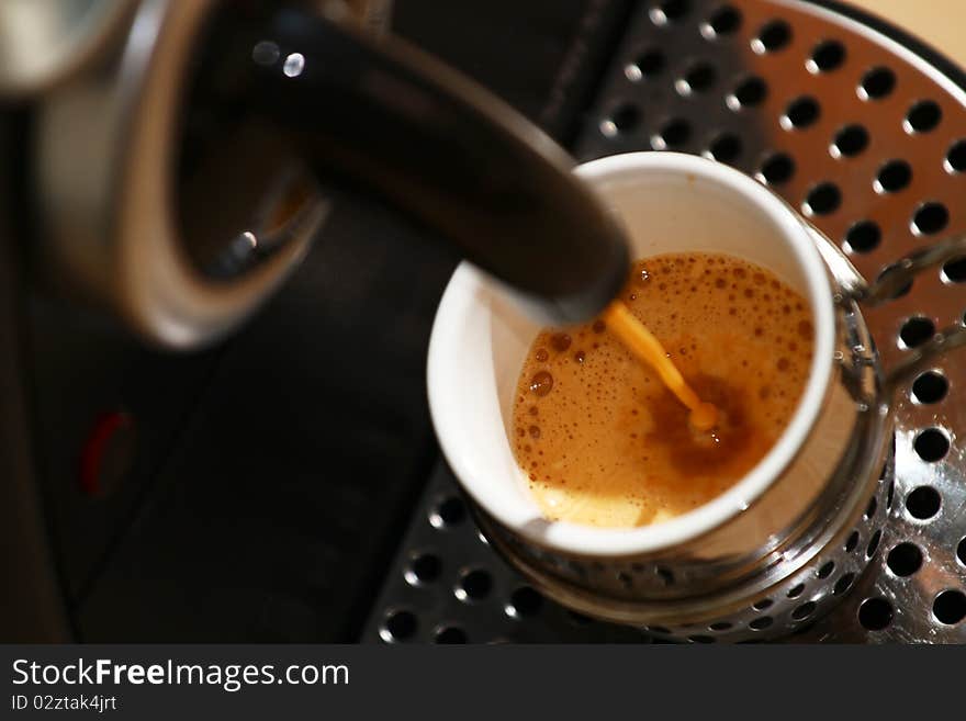 Espresso being made, pouring into a cup. Espresso being made, pouring into a cup.