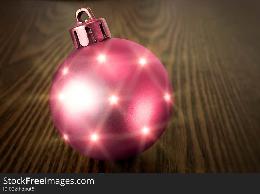 Christmas red ball on a wooden background