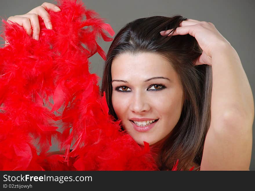 Beautiful Girl Holding Red Feathers