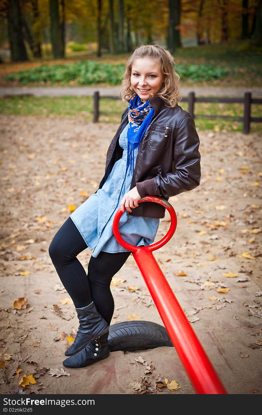 Young caucasian student girl in golden autumn park. Young caucasian student girl in golden autumn park