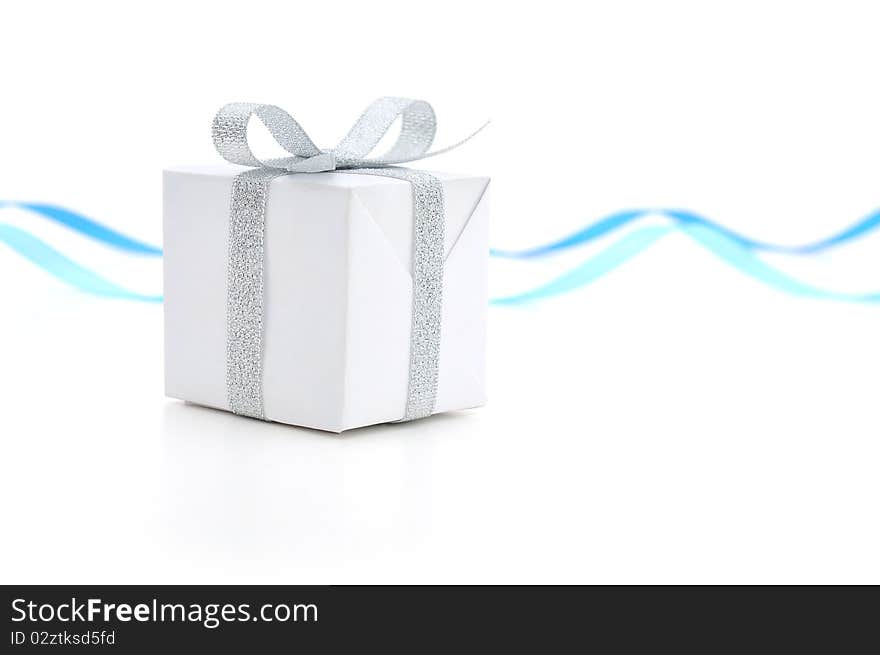 White gift box with a silver bow on white background. White gift box with a silver bow on white background