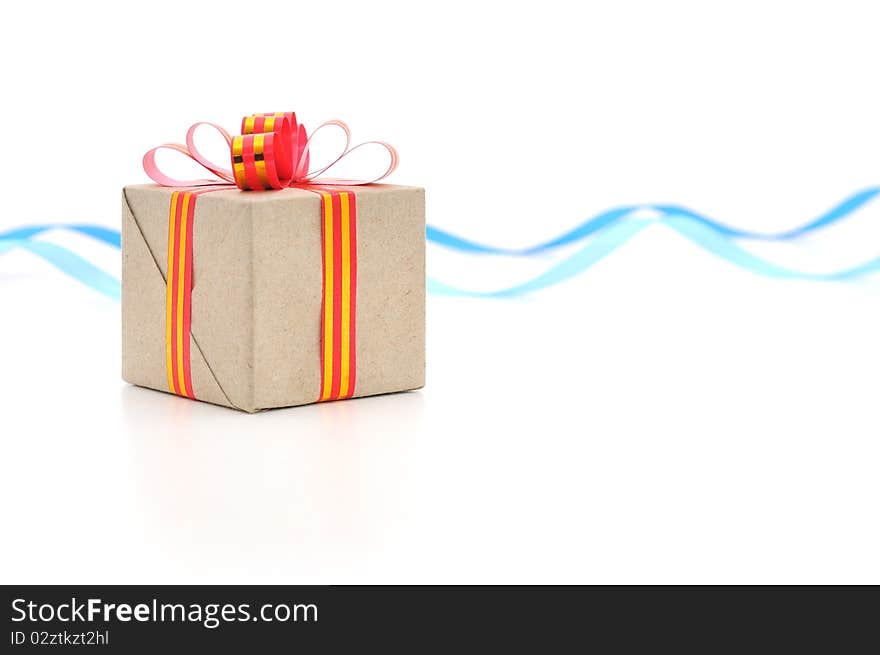 Gift box with gold and red ribbon in white background.