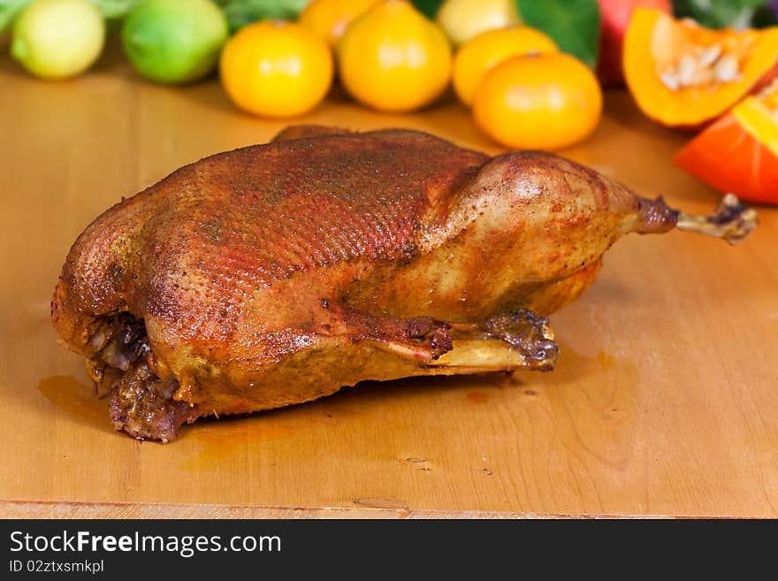 Fresh Baked Goose with decoration of fruits .