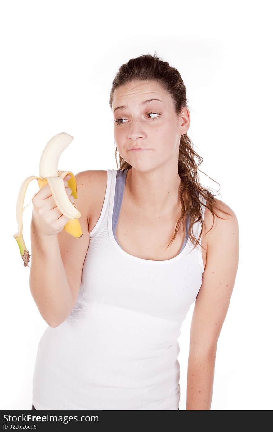 A woman is not sure if she wants to eat a banana. A woman is not sure if she wants to eat a banana.