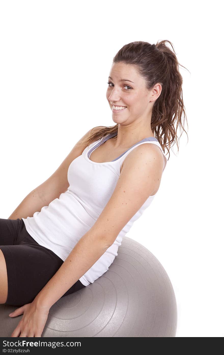 A woman is leaning back on a fitness ball. A woman is leaning back on a fitness ball