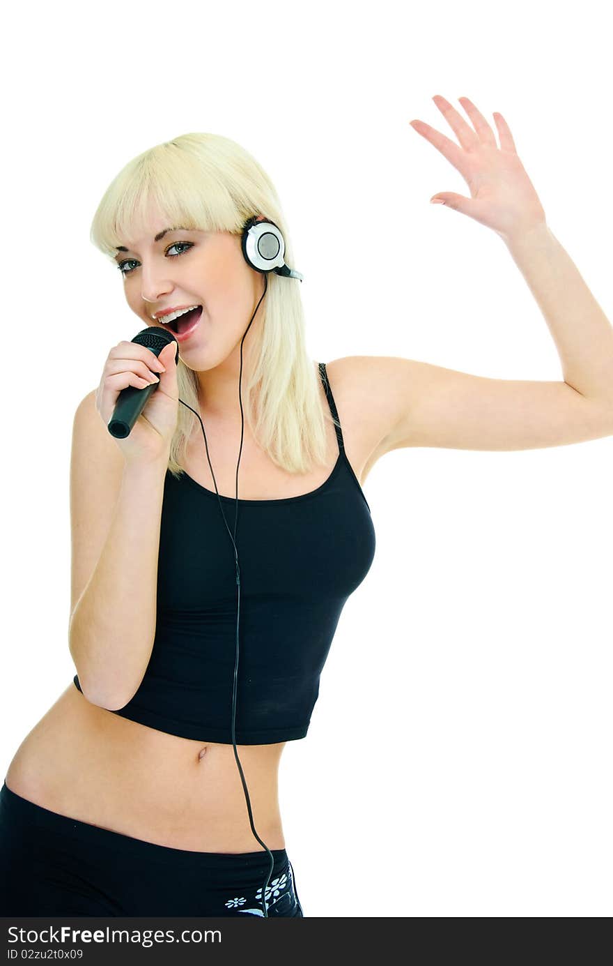 Pretty girl sings to microphone in headphones. Pretty girl sings to microphone in headphones