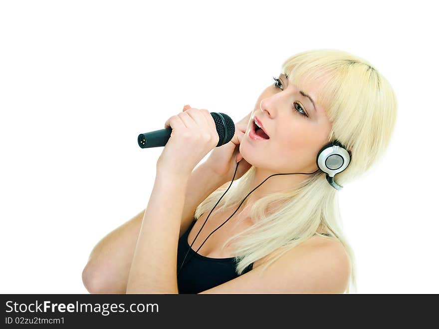 Pretty girl sings to microphone in headphones. Pretty girl sings to microphone in headphones