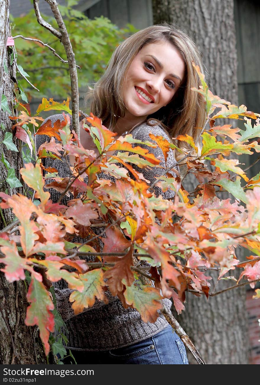 Happy young woman in autumn setting