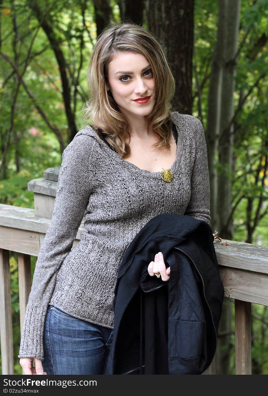 Happy young woman portrait in autumn setting