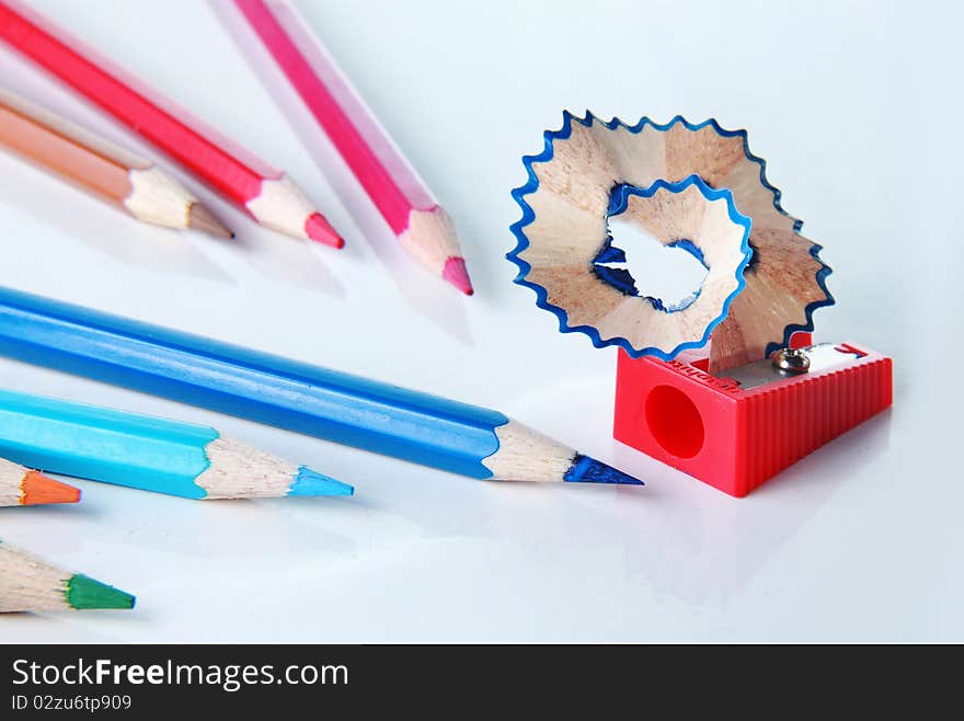 Many color of color pencils with sharpener on the table