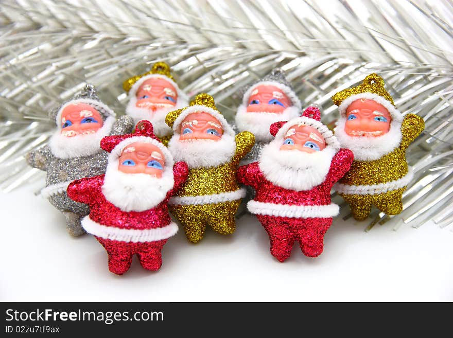 Some dolls of Santa Claus are together isolated on a white background