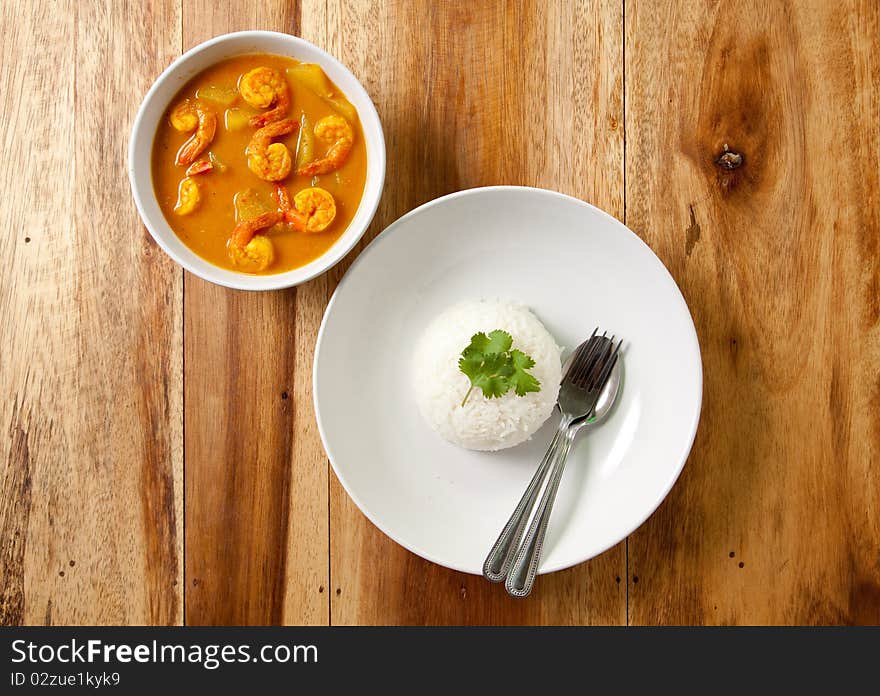 Shrimp curry with rice on wood background,thai food. Shrimp curry with rice on wood background,thai food.