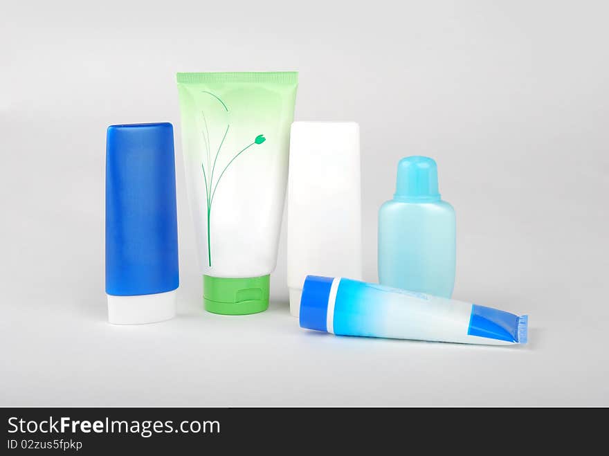 Different cosmetic bottles and tubes isolated on white background . Each object on different layer.