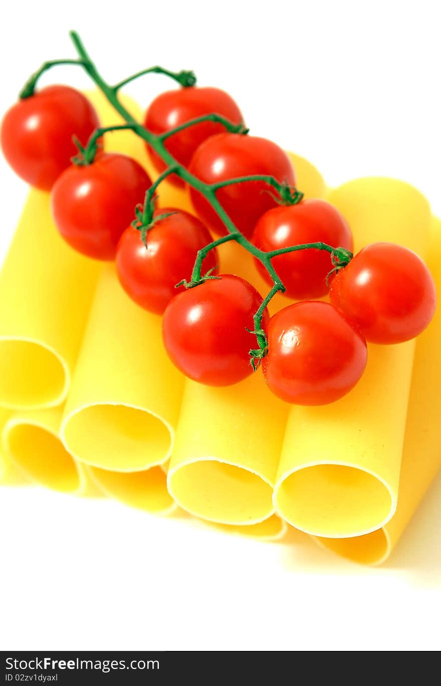 Macaroni and tomatoes on white background. Macaroni and tomatoes on white background