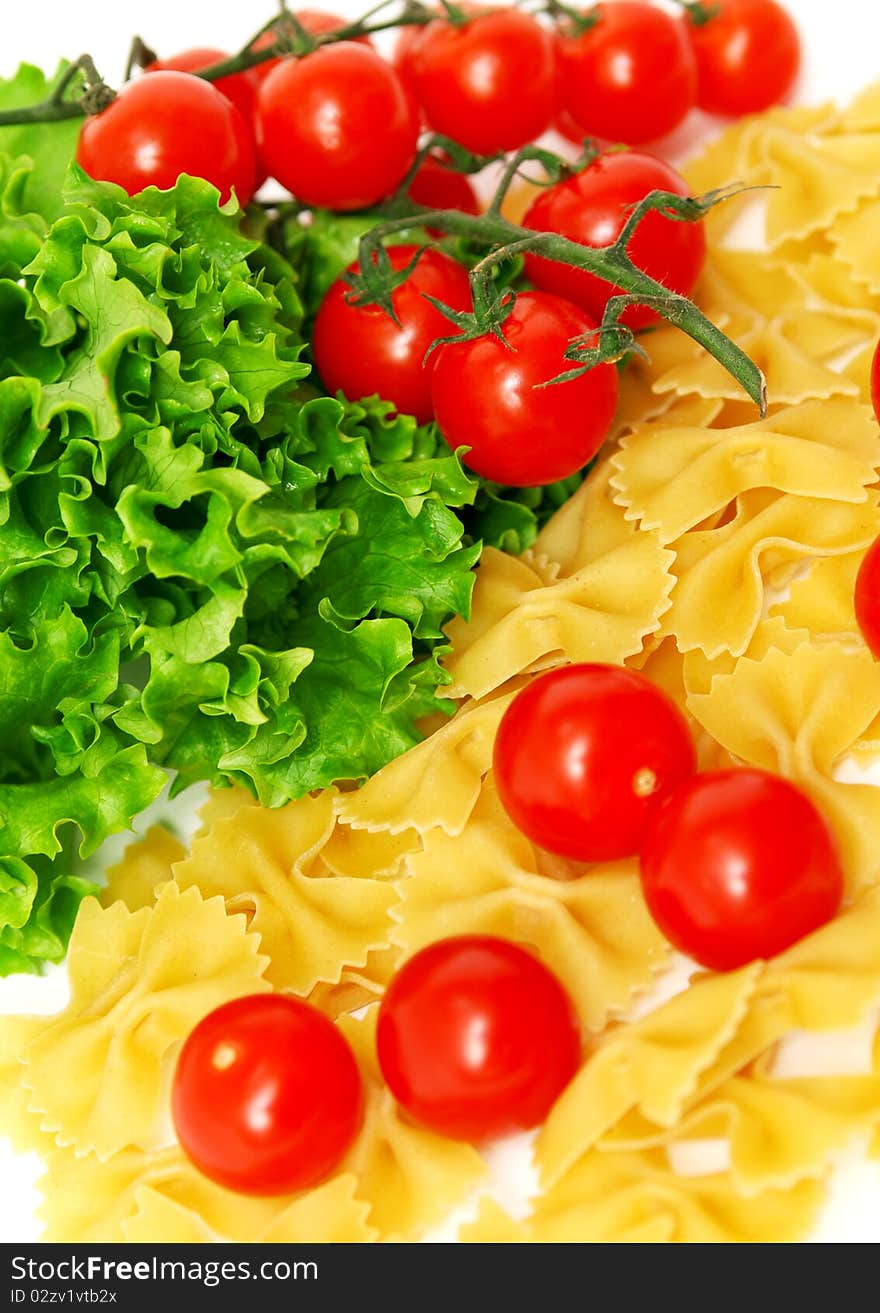 Macaroni and tomatoes on white background. Macaroni and tomatoes on white background