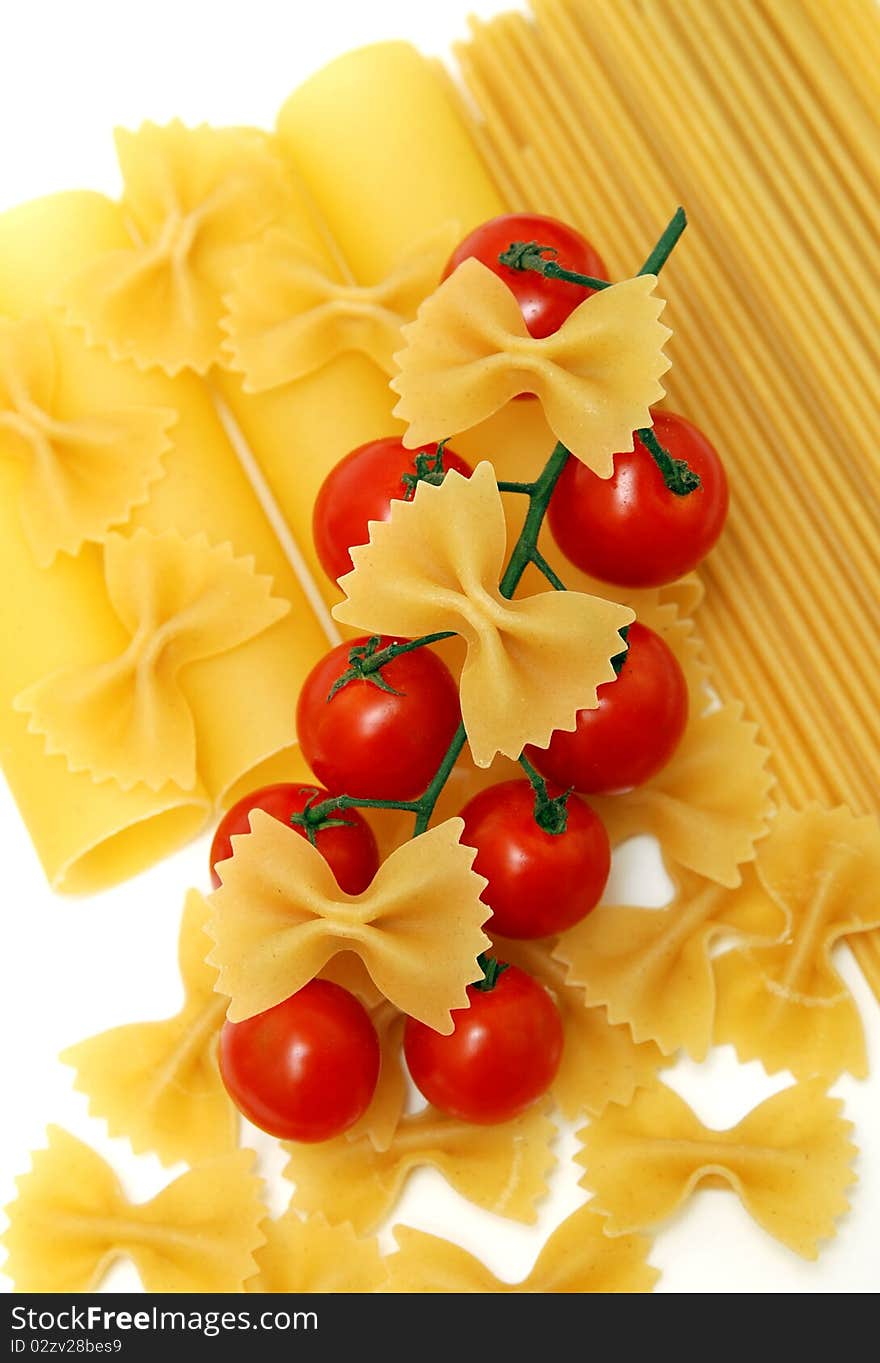 Macaroni and tomatoes on white background. Macaroni and tomatoes on white background