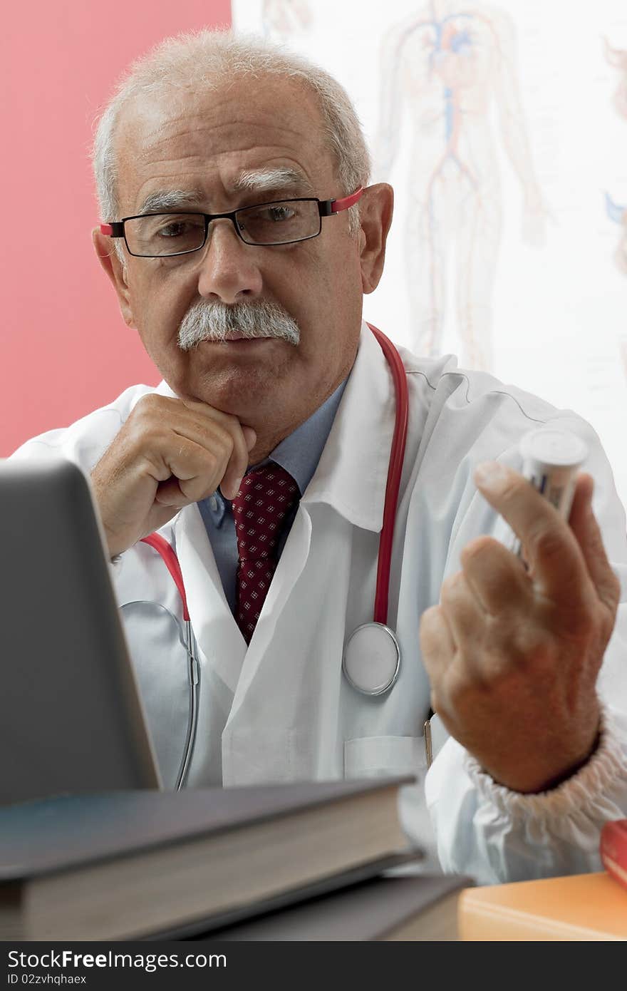 Senior doctor speaking with patient through webcam. Senior doctor speaking with patient through webcam