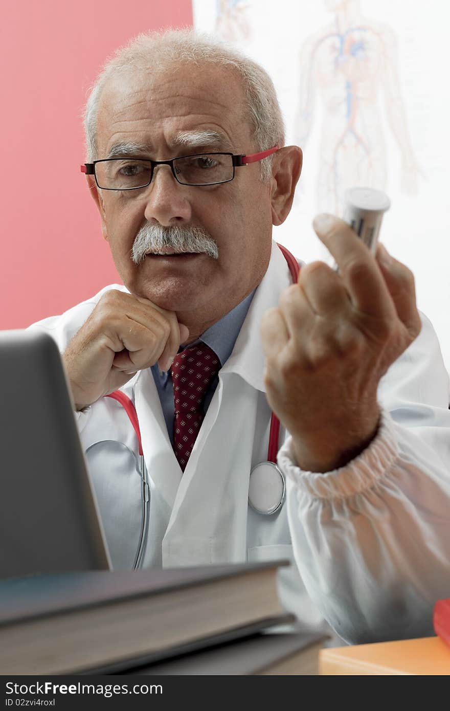 Senior doctor speaking with patient through webcam. Senior doctor speaking with patient through webcam