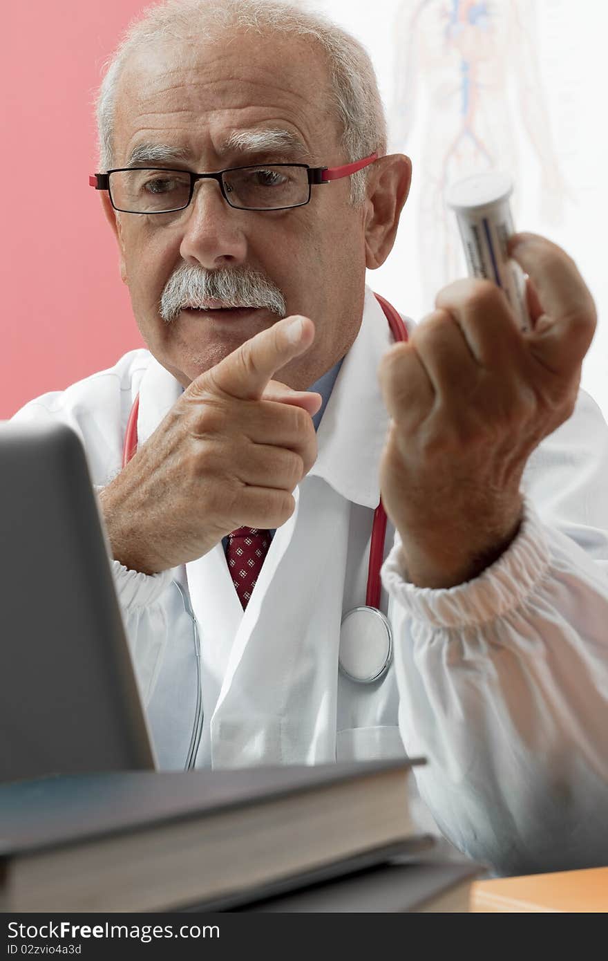 Senior doctor speaking with patient through webcam. Senior doctor speaking with patient through webcam