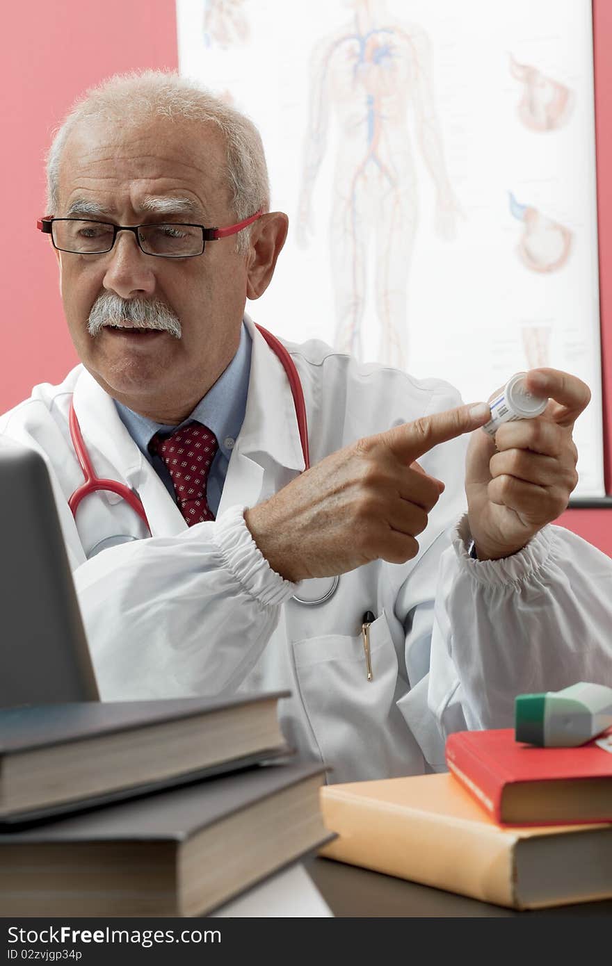 Senior doctor speaking with patient through webcam. Senior doctor speaking with patient through webcam