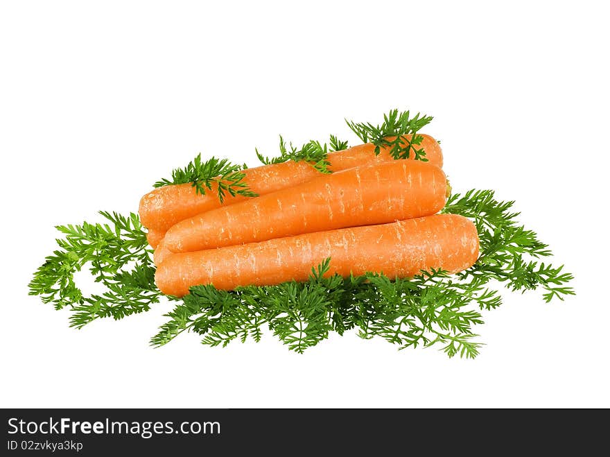 Carrots stacket up with leaves around on white background