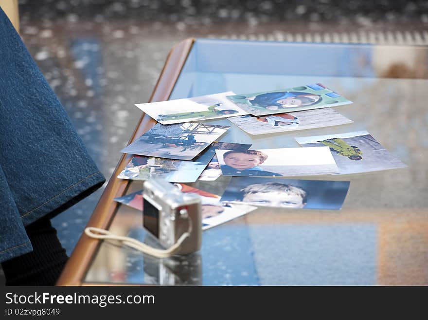 Photographs spread over the table. Photographs spread over the table