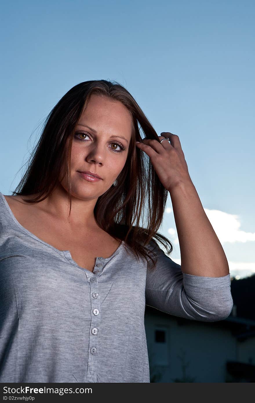 Young beautiful woman with blue sky in the background. Young beautiful woman with blue sky in the background