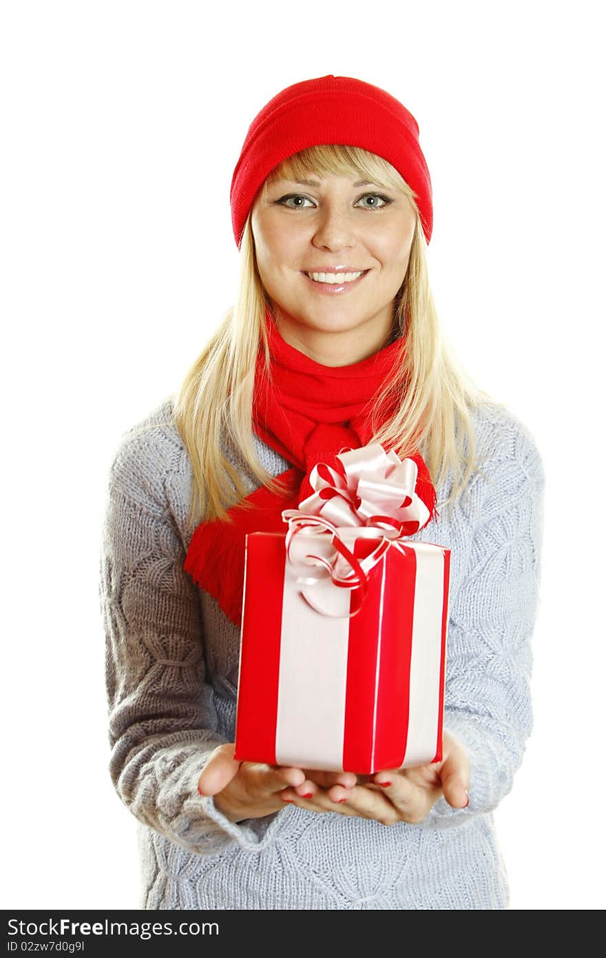 Young beautiful woman in a blue knitted sweater, red hat and red scarf holding a Christmas gift box. Young beautiful woman in a blue knitted sweater, red hat and red scarf holding a Christmas gift box