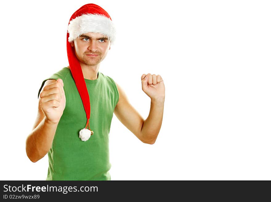 Young man in a Santa Claus hat and green poppy fun, celebrates and moves in the dance. Young man in a Santa Claus hat and green poppy fun, celebrates and moves in the dance