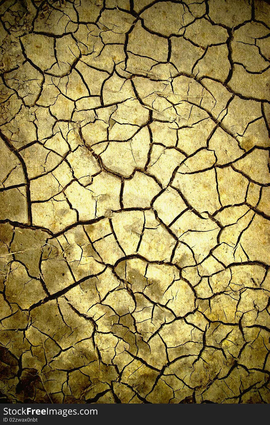 Parched, cracked soil in the hot sun. Parched, cracked soil in the hot sun.