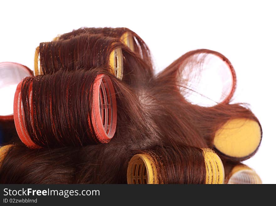 Close-up of curlers in hair isolated on white