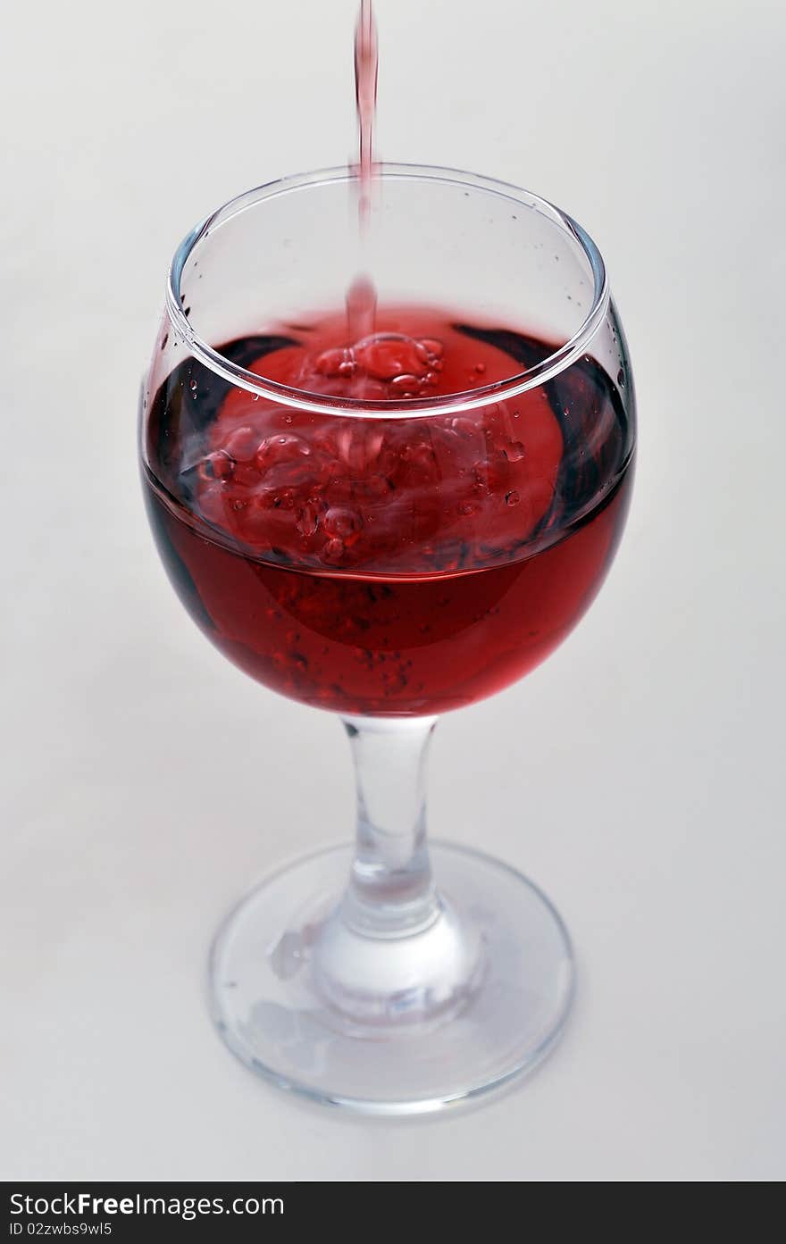 Red wine pouring into a wine glass