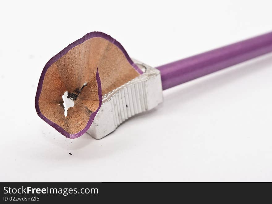 Sharp pencil and shaving on white background