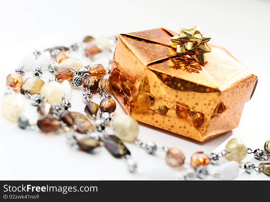 Golden gift box with decoration, on white