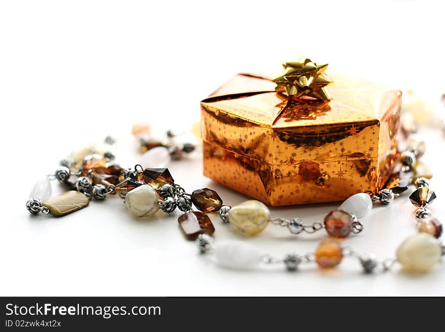 Golden gift box with decoration, on white