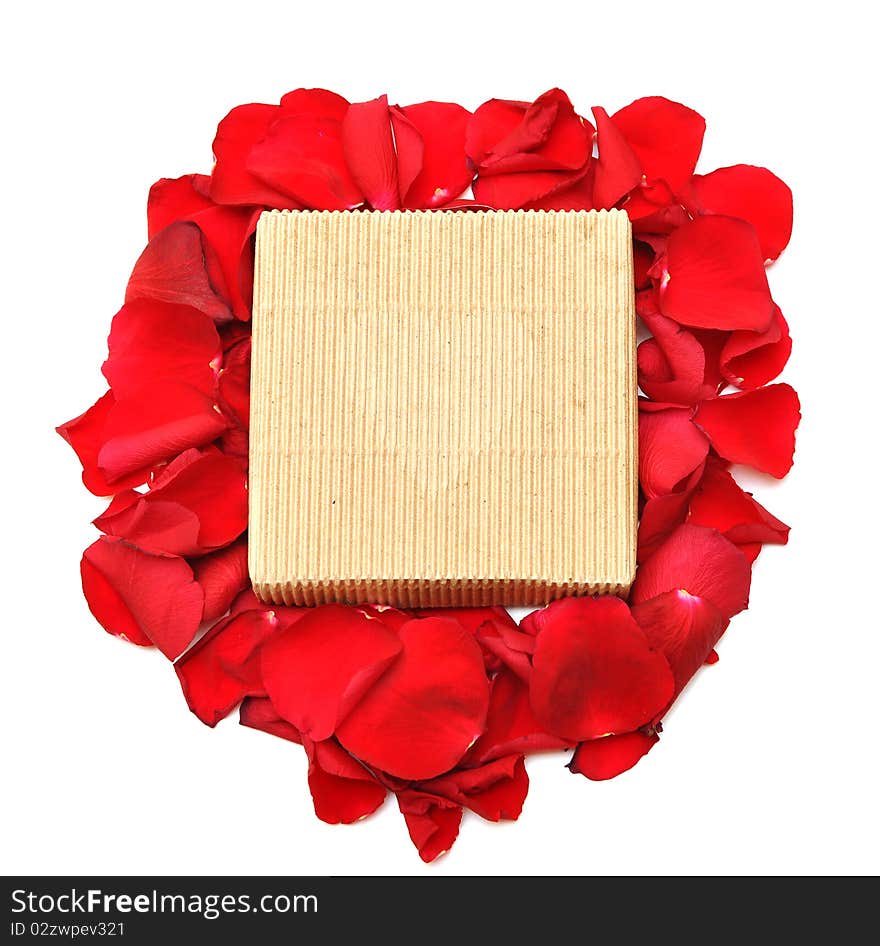 Red rose petals and gift on white background