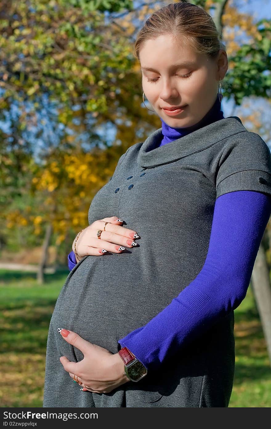 Beautiful pregnant woman in the park. Beautiful pregnant woman in the park