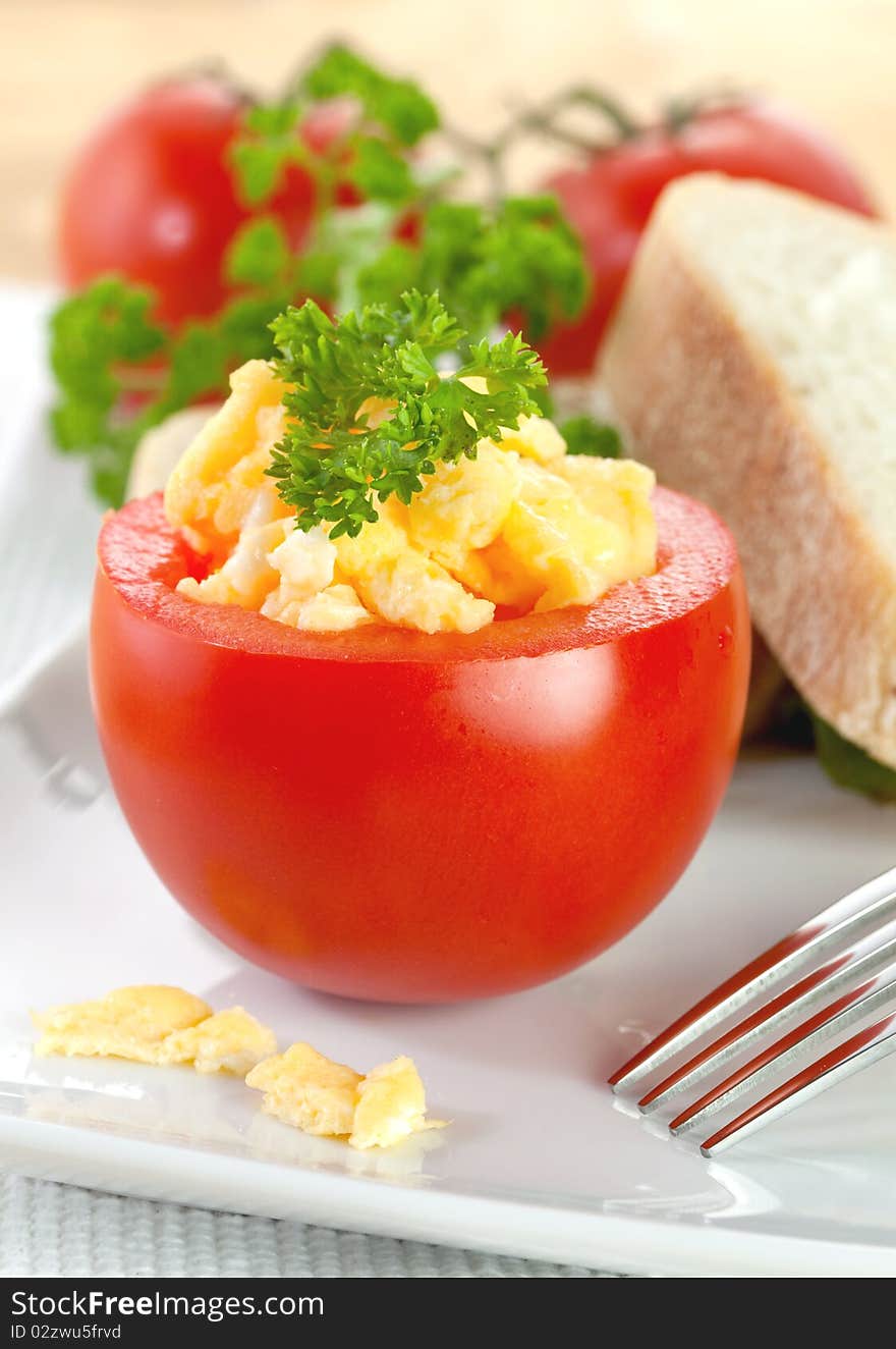 Fresh tomato with scrambled eggs and parsley. Fresh tomato with scrambled eggs and parsley