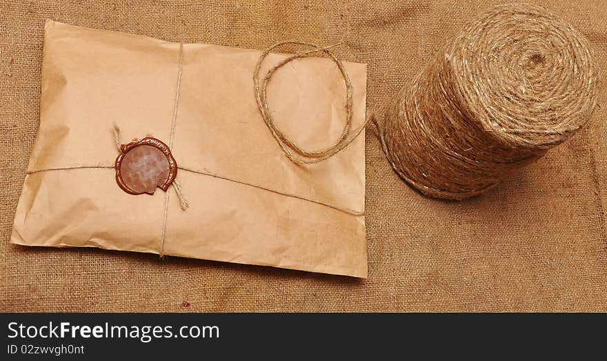 String hank and parcel on sack background